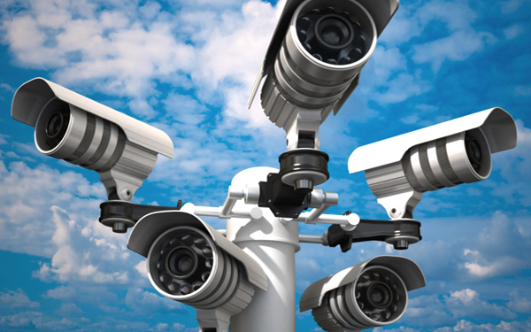 A group of various security cameras attached to a pole