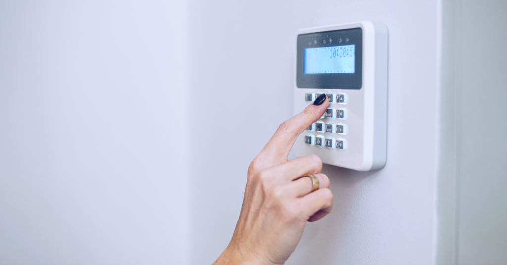 woman's hand using a home security system